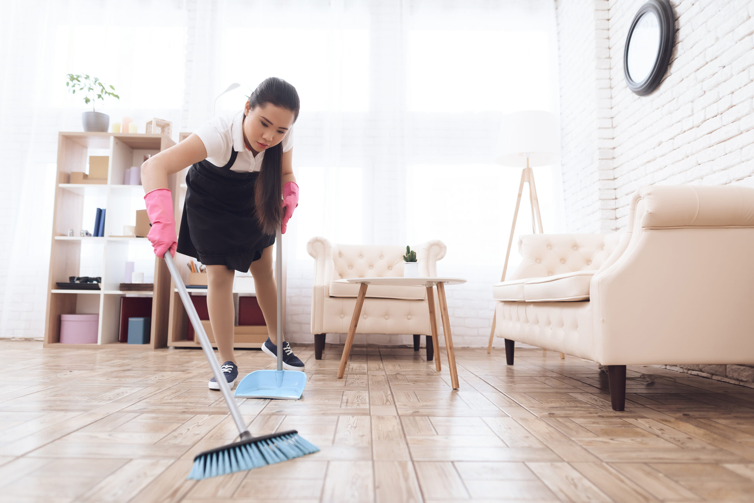 Thai Girl Sweeping Floor with Broom and Scoop.